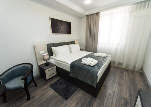 Postel nebo postele na pokoji v ubytování Downtown Suites Yerevan
