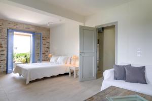 a living room with two beds and a couch at VILLA SOROS in Antiparos
