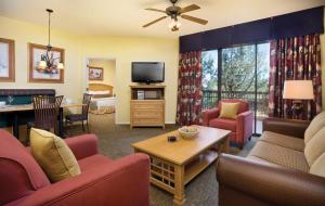 a living room with couches and a tv and a table at Club Wyndham Sedona in Sedona