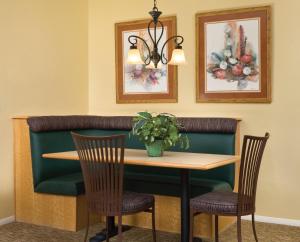 a dining room with a table and two chairs at Club Wyndham Sedona in Sedona