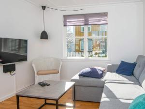 een woonkamer met een bank en een tafel bij 7 person holiday home on a holiday park in Ebeltoft in Ebeltoft