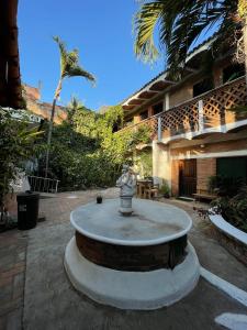 a fountain in the middle of a courtyard at Hosteria Chata Adults Only in Lo de Marcos
