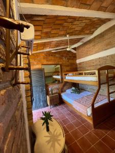 a room with two bunk beds and a table at Hosteria Chata Adults Only in Lo de Marcos