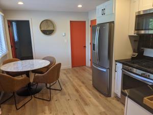 a kitchen with a table and chairs and a refrigerator at 4411 Inn & Suites in Michigan City