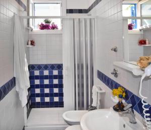 a bathroom with a toilet and a sink at Favignana Casa Vacanza Orsola in Favignana