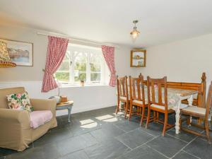 a living room with a table and chairs at Chapel Cottage in Bideford