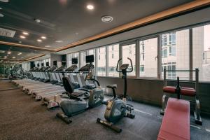 a gym with rows of exercise bikes and treadmills at Best Western Plus Hotel Sejong in Sejong