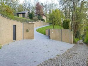 a driveway with two entrances to a brick building at Picturesque villa in Bierges with swimming pool and barbeque in Bierges