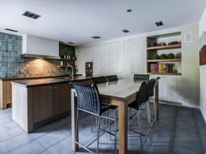cocina con mesa de madera y sillas en Classy Apartment in Weelde with Swimming Pool, en Weelde