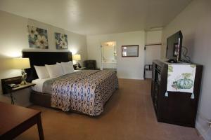 ウェストポートにあるMariners Cove Innのベッド1台、薄型テレビが備わるホテルルームです。