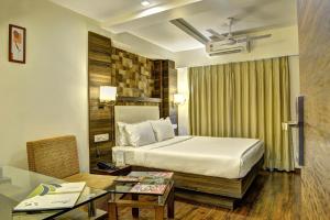 Postel nebo postele na pokoji v ubytování Hotel Aaram Orchard + 27 fotografií