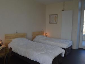 2 camas en una habitación de hotel con sábanas blancas en Gîte Lingé, 2 pièces, 2 personnes - FR-1-591-189, en Lingé