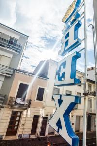 a building with a sign in front of it at Hotel Rex in Viareggio