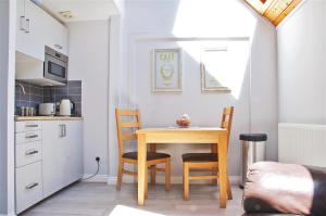 a kitchen with a table and chairs in a room at Northlands Farm Superior Chalet 3 in Chichester