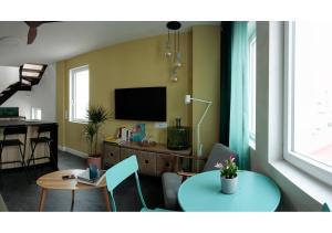 a living room with a table and a television at CasaMARta2 in Conil de la Frontera
