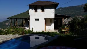 a house with a swimming pool in front of it at Villa Gorno Melnicani in Debar