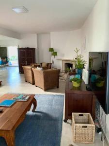 a living room with a couch and a table at CASA DAS CORES - Sesimbra in Sesimbra