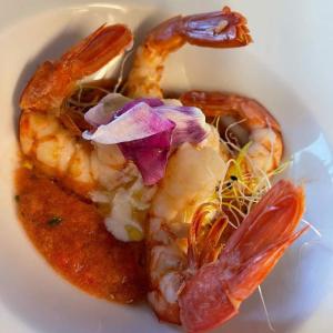 a plate of food with shrimp and other foods at "La Locanda" Campione del Garda in Campione del Garda