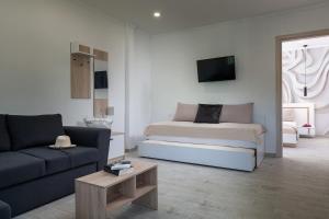 a living room with a bed and a couch at Estell apartments in Sykia Chalkidikis