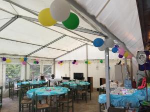 a tent set up for a party with tables and balloons at Appartements et Chambres Le Vaumurier de Saint Lambert in Saint-Lambert