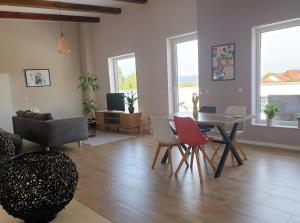 a living room with a table and chairs at Oleander Hof in Hochstadt
