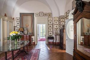 a living room with a table and a refrigerator at Palazzo Bernardini Suites in Lecce