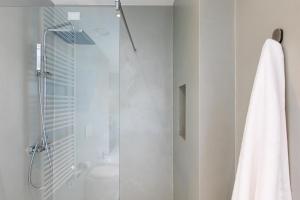 a bathroom with a shower with a glass door at Missori Suites in Milan