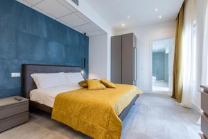 a bedroom with a bed and a blue wall at Missori Suites in Milan