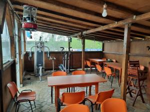 a restaurant with tables and chairs and a heater at Casa Antonia si Maria in Ostrov