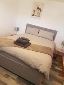 een slaapkamer met een bed met twee handdoeken erop bij Maria's place (central Ballycastle 3 Bedroom) in Ballycastle