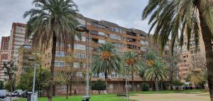 un grande edificio con palme di fronte di Vivienda Turistica Valencia A3 a Valencia
