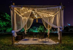 an outdoor ceremony with chairs under a canopy with lights at Suite Acropolis Serres Parking EV Next to Center in Serres