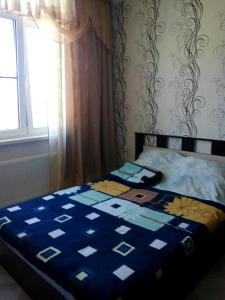 מיטה או מיטות בחדר ב-Apartment on Parkovaya