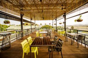 a restaurant with tables and chairs and a view of the ocean at Gateway Hotel in Port Moresby