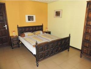 a bedroom with a large wooden bed in a room at Finca Gerardo Miraflor in La Playa Calera
