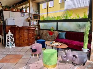 a living room with a couch and a table at Casa Merano Residence & Ristorante Bibione Centro in Bibione