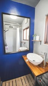 a bathroom with a white sink and a mirror at Furano View House in Furano