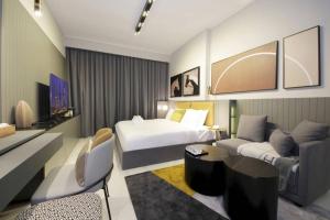 a hotel room with a bed and a couch at New Arabian MAG 318 Business Bay in Dubai
