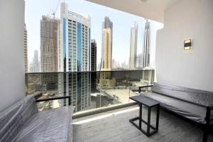 a balcony with a bench and a view of a city at New Arabian MAG 318 Business Bay in Dubai