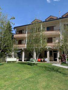 a building with a green yard in front of it at Hotel Garden in Fino del Monte