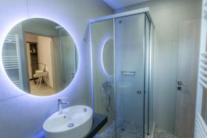 a bathroom with a sink and a shower with a mirror at ERMIS in Ioannina