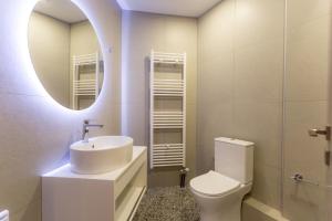 a bathroom with a sink and a toilet and a mirror at ERMIS in Ioannina +7 photos