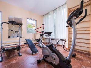 a gym with three exercise bikes in a room at Offenburg City Hotel by Belvilla in Offenburg