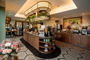 a hair salon with a large chandelier above a counter at Grand Hotel Valies in Roermond