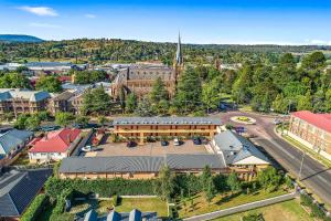 an aerial view of a small town with a church at City Centre Motel Armidale in Armidale +57 photos