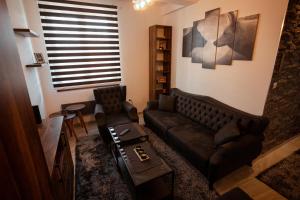 a living room with a couch and a table at Zlatar Apartman br 16 in Brdo