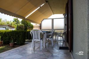 a table and chairs under an umbrella on a patio at Eirini Kasimiotou Apartments in Agios Andreas +46 photos