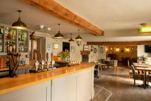 a bar in a pub with a dining area at The Red Lion Arlingham in Gloucester