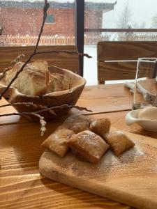 a bunch of bread on a cutting board on a table at Albanian traditional Villa in Librazhd