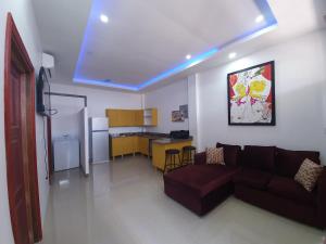 a living room with a couch and a kitchen at Apex boutique apartments in Georgetown